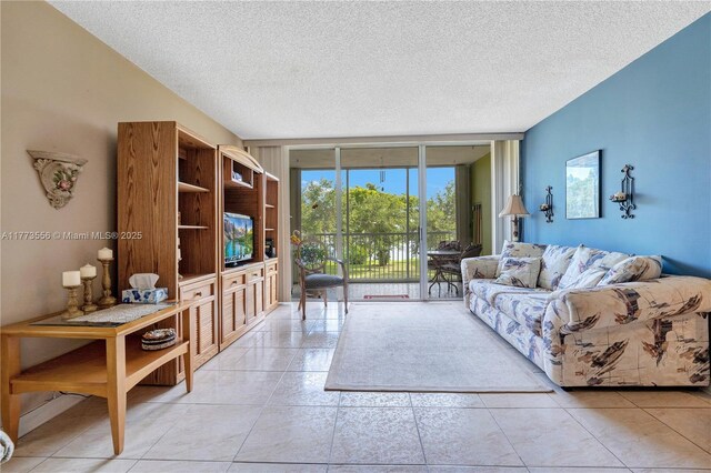 922 NE 199th St Unit 206, Miami, FL 33179 - living area with a textured ceiling and tile patterned floors