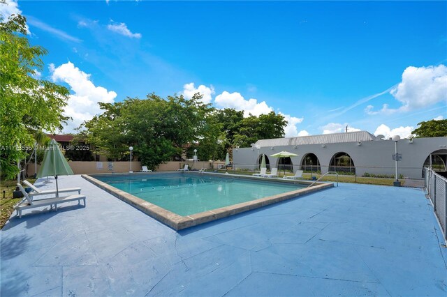 922 NE 199th St Unit 206, Miami, FL 33179 - community pool with fence and a patio area