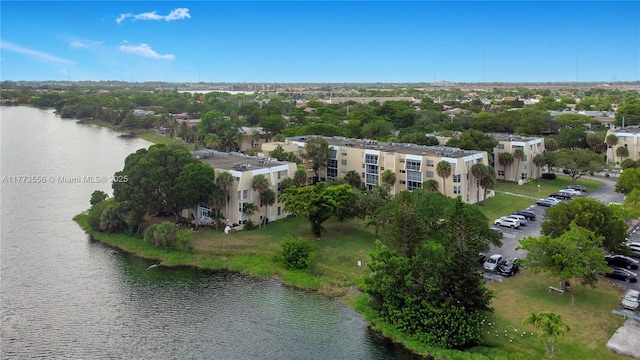 aerial view of property and surrounding area featuring a nearby body of water