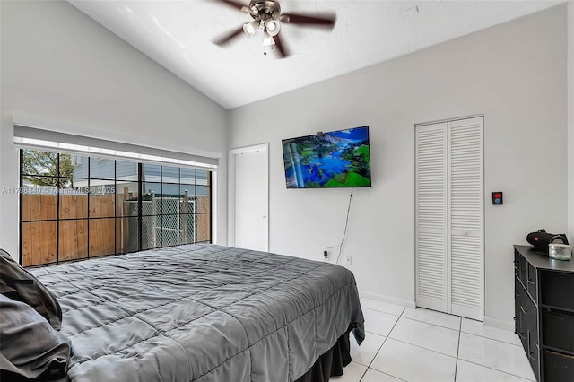 bedroom with lofted ceiling, baseboards, light tile patterned floors, and ceiling fan