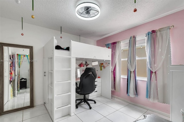 home office with a textured ceiling and light tile patterned floors