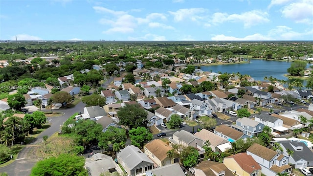 view of property location with a nearby body of water and nearby suburban area