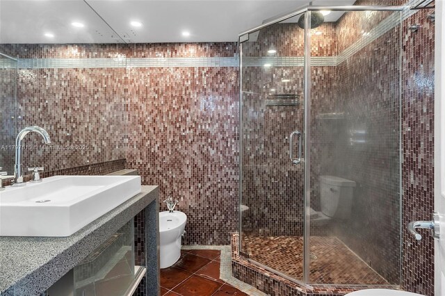 full bathroom featuring tile walls, tile patterned floors, a stall shower, a bidet, and toilet
