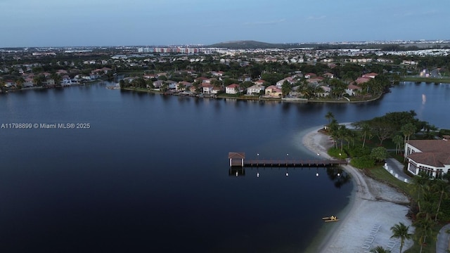 view of property location featuring a nearby body of water and nearby suburban area