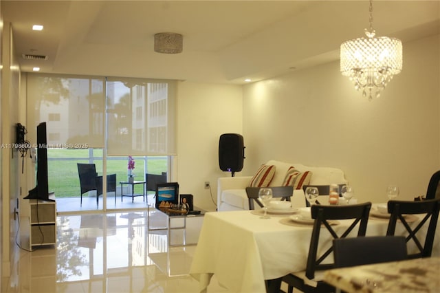 living room featuring a chandelier, recessed lighting, and a wall of windows