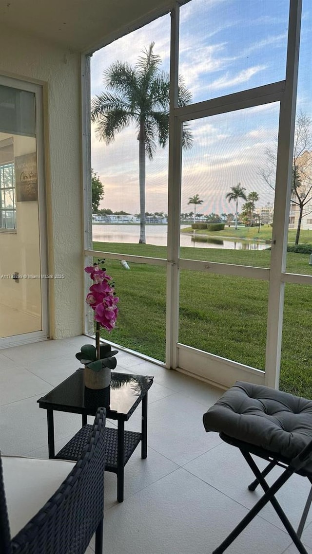 sunroom / solarium with a water view