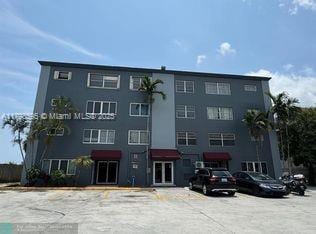 view of building exterior with uncovered parking