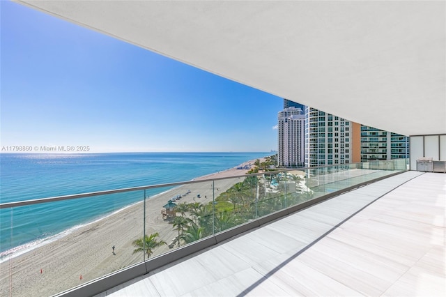 balcony with view of water and beach