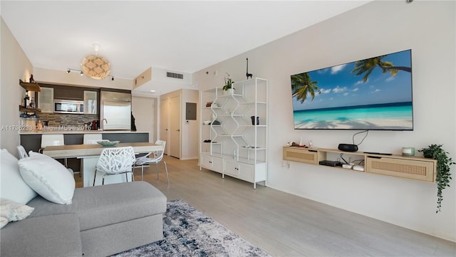 living area with wood finished floors and baseboards