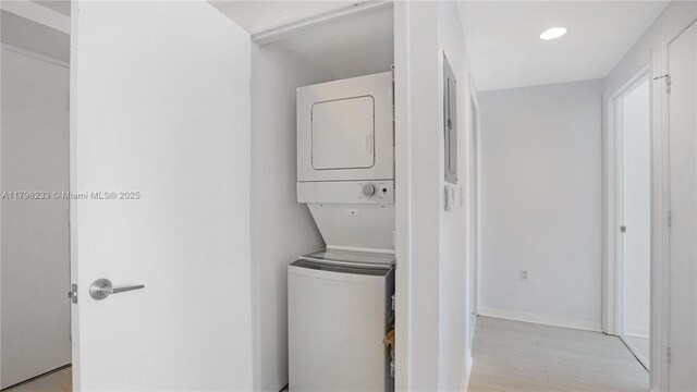 55 SE 6th St Unit 1804, Miami, FL 33131 - laundry room featuring stacked washer / drying machine, baseboards, light wood-type flooring, and recessed lighting
