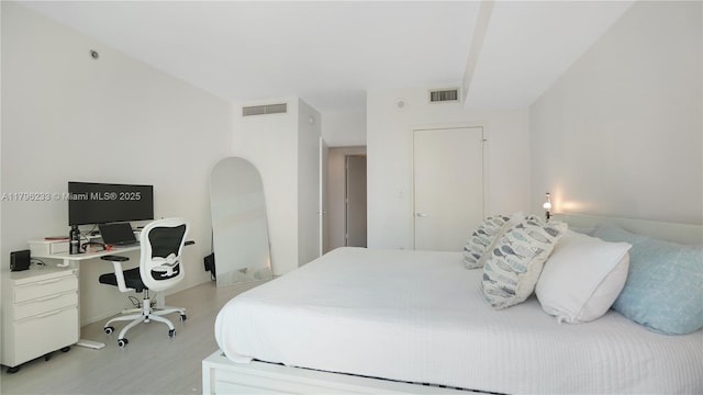 bedroom with wood finished floors, a desk, and baseboards