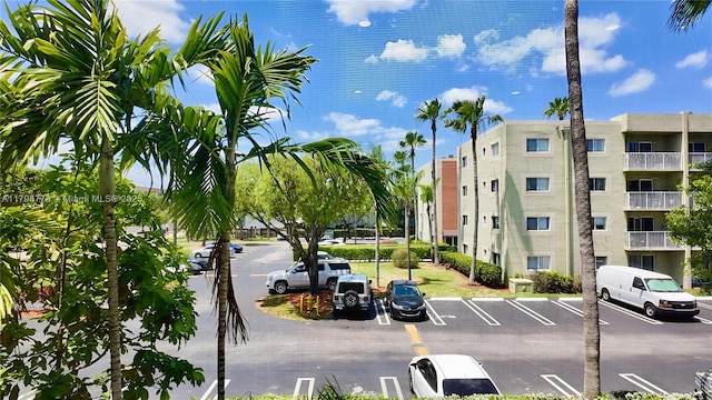 view of apartment building / complex with uncovered parking