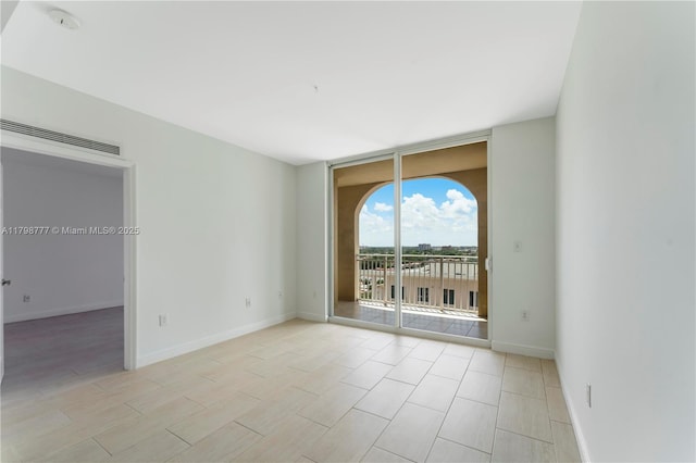 2425 SW 27th Ave Unit 1408, Miami, FL 33145 - spare room featuring floor to ceiling windows and baseboards