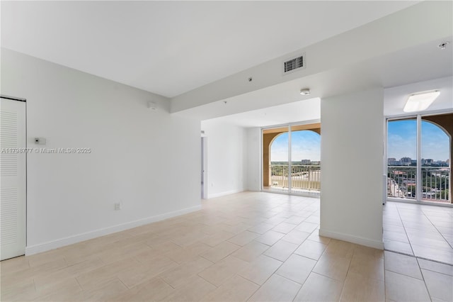 2425 SW 27th Ave Unit 1408, Miami, FL 33145 - spare room with baseboards, fire sprinkler in ceiling, and light tile patterned floors