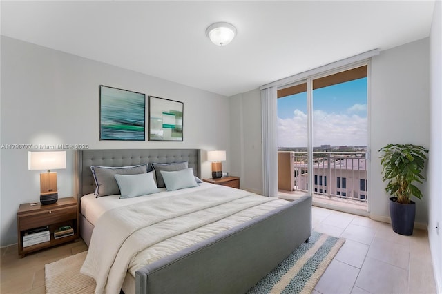 2425 SW 27th Ave Unit 1408, Miami, FL 33145 - bedroom featuring a wall of windows, access to exterior, light tile patterned flooring, and baseboards