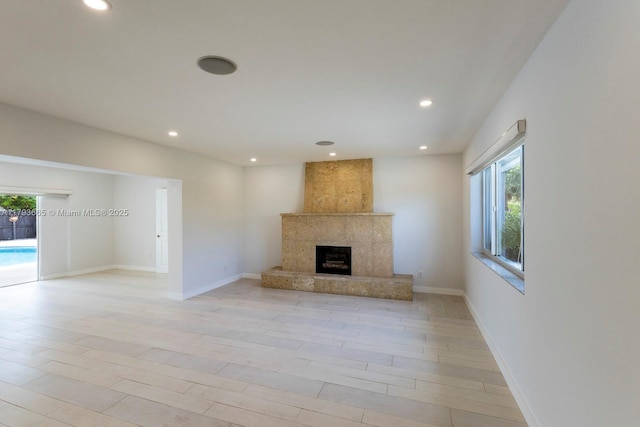 11210 SW 181st St, Miami, FL 33157 - unfurnished living room with a premium fireplace, recessed lighting, baseboards, and light wood-style floors