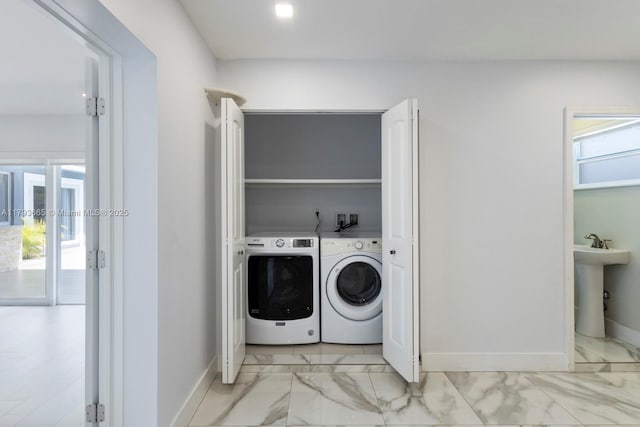 11210 SW 181st St, Miami, FL 33157 - clothes washing area featuring washing machine and clothes dryer, light marble finish flooring, baseboards, and plenty of natural light