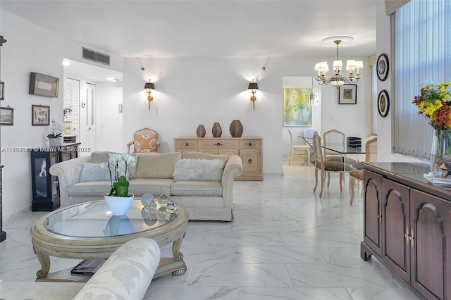 living room with light marble finish flooring and a chandelier