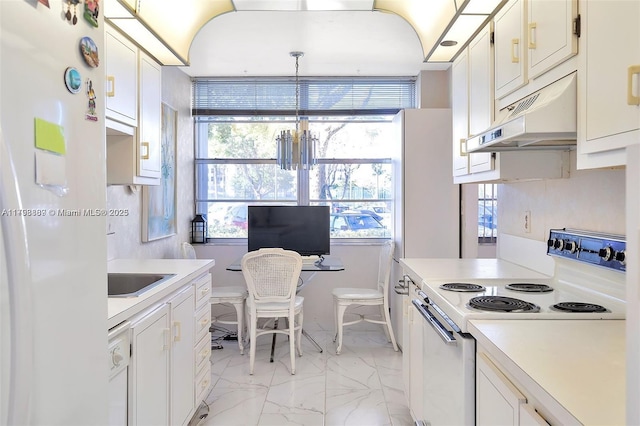 kitchen featuring white appliances, under cabinet range hood, light countertops, and light marble finish floors