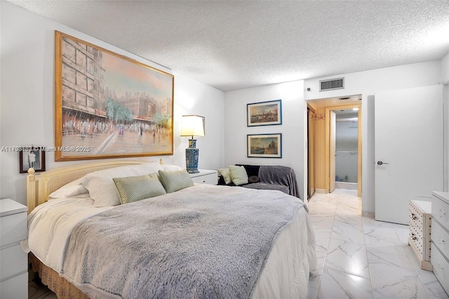 bedroom with light marble finish flooring and a textured ceiling