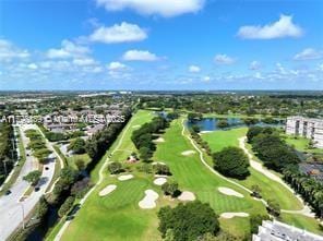 view of property location featuring a golf club and a large body of water