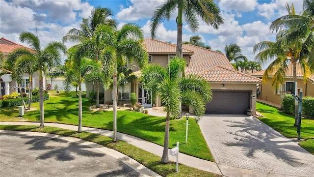 12672 Tucano Cir, Boca Raton, FL 33428 - mediterranean / spanish home with a tile roof, an attached garage, stucco siding, and a front lawn