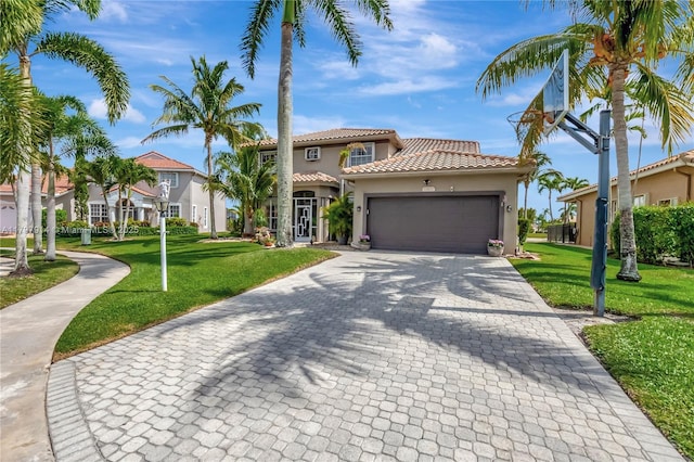 12672 Tucano Cir, Boca Raton, FL 33428 - mediterranean / spanish-style house with stucco siding, decorative driveway, a tile roof, an attached garage, and a front lawn