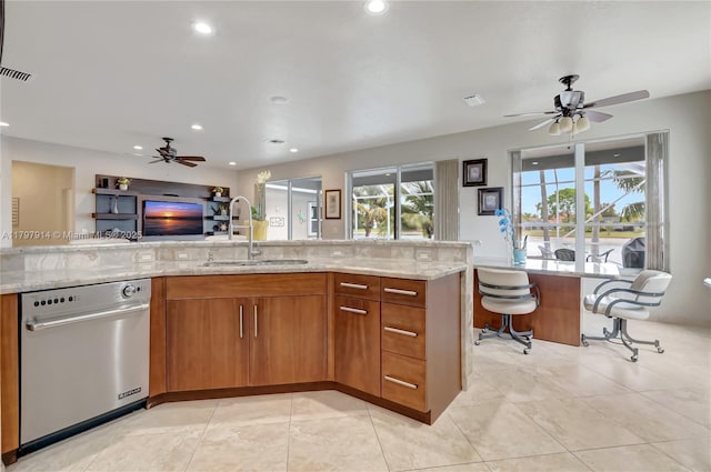 12672 Tucano Cir, Boca Raton, FL 33428 - kitchen featuring stainless steel dishwasher, a sink, ceiling fan, brown cabinets, and recessed lighting