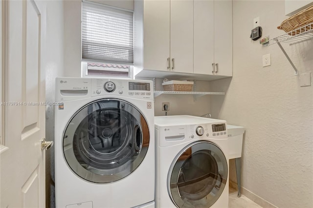 12672 Tucano Cir, Boca Raton, FL 33428 - laundry area with separate washer and dryer, cabinet space, baseboards, and a textured wall