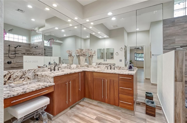 12672 Tucano Cir, Boca Raton, FL 33428 - bathroom featuring recessed lighting, plenty of natural light, double vanity, a walk in shower, and wood finished floors