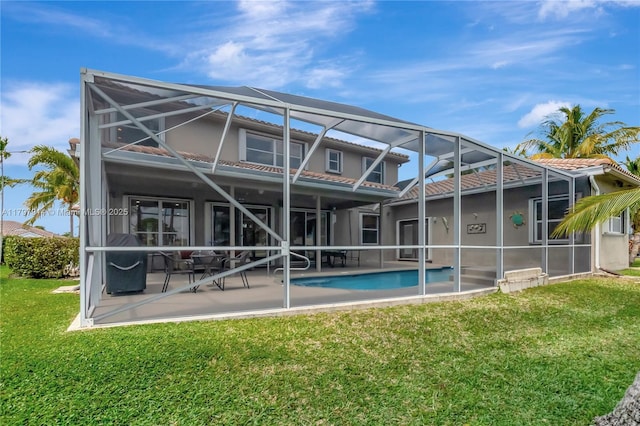 12672 Tucano Cir, Boca Raton, FL 33428 - rear view of house featuring glass enclosure, a patio, a yard, an outdoor pool, and a tiled roof