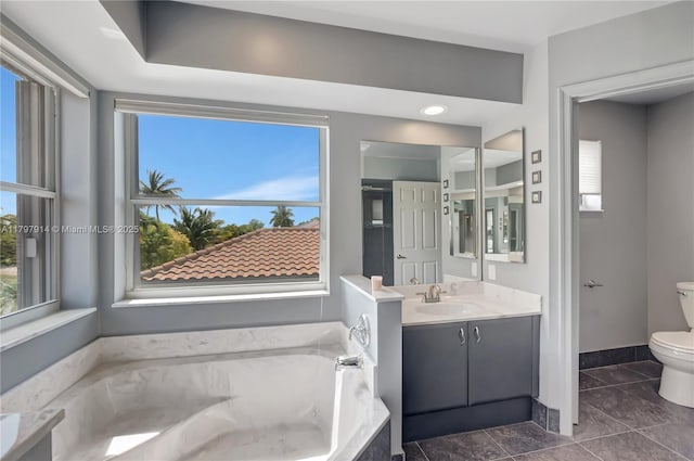 12672 Tucano Cir, Boca Raton, FL 33428 - bathroom with toilet, a garden tub, vanity, tile patterned flooring, and baseboards