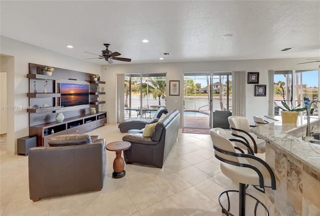 12672 Tucano Cir, Boca Raton, FL 33428 - living area featuring a ceiling fan, recessed lighting, light tile patterned floors, and a textured ceiling