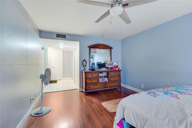 4848 NW 24th Ct Unit 215, Lauderdale Lakes, FL 33313 - bedroom with wood finished floors, baseboards, and a ceiling fan