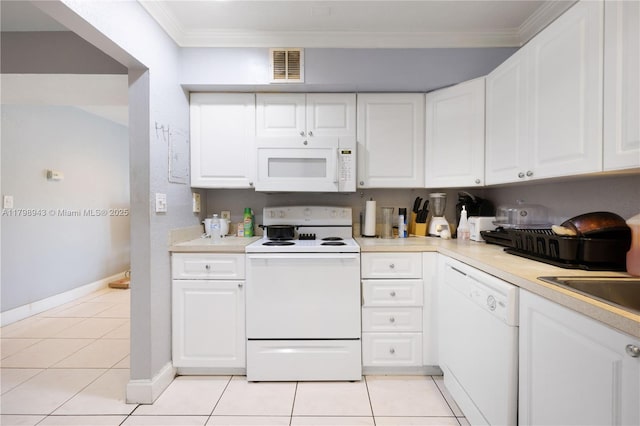 4848 NW 24th Ct Unit 215, Lauderdale Lakes, FL 33313 - kitchen featuring white appliances, baseboards, light countertops, crown molding, and white cabinets
