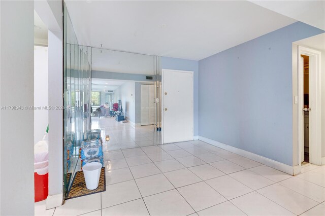 4848 NW 24th Ct Unit 215, Lauderdale Lakes, FL 33313 - empty room with light tile patterned floors and baseboards