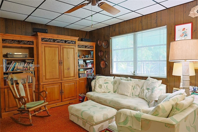 10610 SW 103rd St, Miami, FL 33176 - carpeted living room featuring wood walls and a ceiling fan