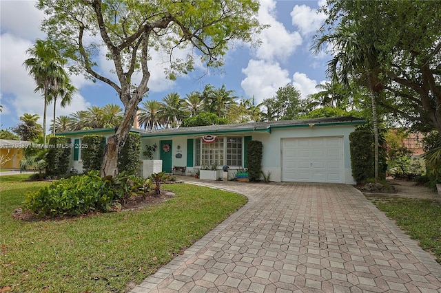 10610 SW 103rd St, Miami, FL 33176 - single story home featuring an attached garage, decorative driveway, stucco siding, and a front yard