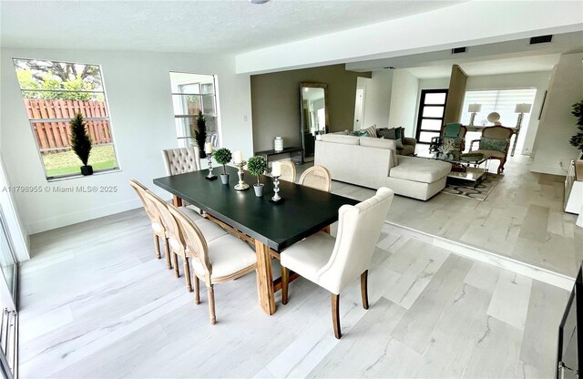2406 Marathon Ln, Fort Lauderdale, FL 33312 - dining room with light wood-type flooring, baseboards, and a textured ceiling