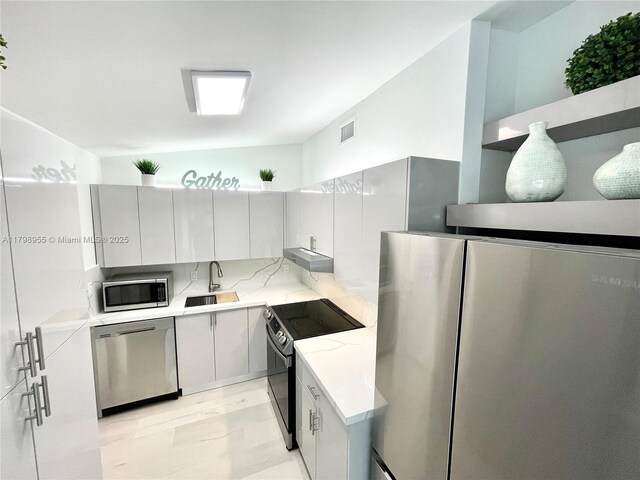 2406 Marathon Ln, Fort Lauderdale, FL 33312 - kitchen featuring stainless steel appliances, a sink, light stone countertops, and under cabinet range hood