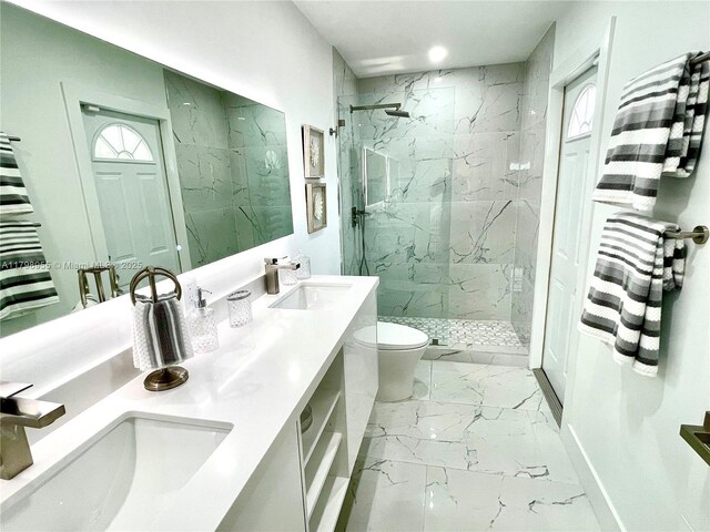2406 Marathon Ln, Fort Lauderdale, FL 33312 - full bath featuring marble look tiles, toilet, a marble finish shower, double vanity, and healthy amount of natural light