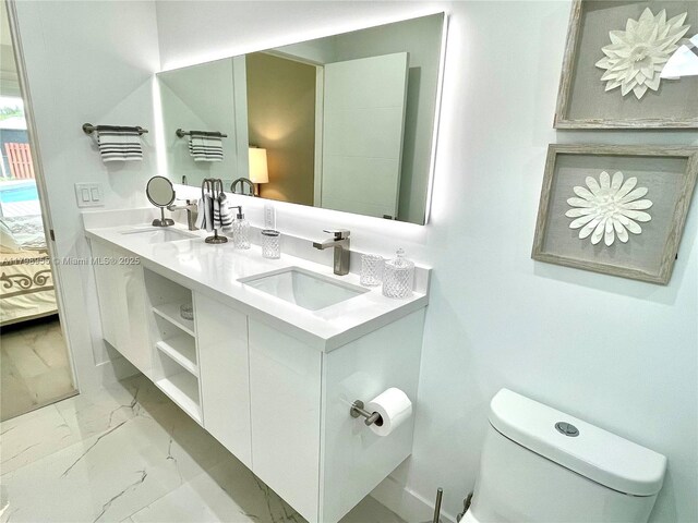 2406 Marathon Ln, Fort Lauderdale, FL 33312 - full bathroom with toilet, double vanity, marble finish flooring, and ensuite bath