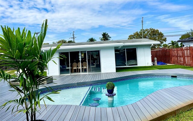 2406 Marathon Ln, Fort Lauderdale, FL 33312 - view of pool with fence, a wooden deck, an outbuilding, and an exterior structure