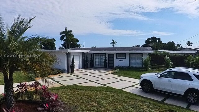 2406 Marathon Ln, Fort Lauderdale, FL 33312 - view of front of property with a garage, stucco siding, and concrete driveway