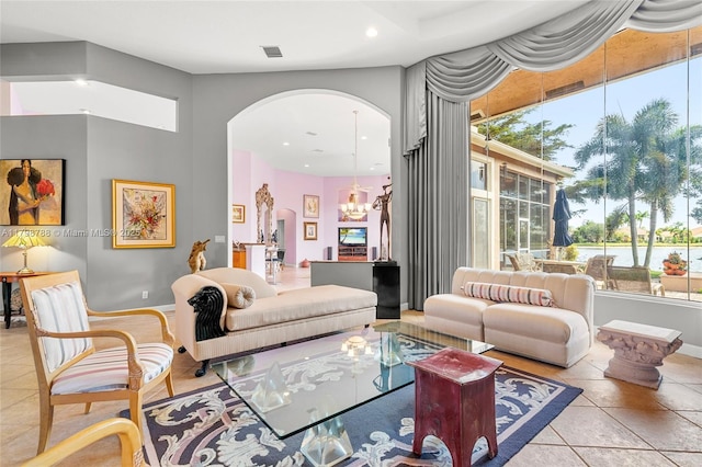 8100 Muirhead Cir, Boynton Beach, FL 33472 - living area featuring arched walkways, healthy amount of natural light, tile patterned flooring, recessed lighting, and a chandelier