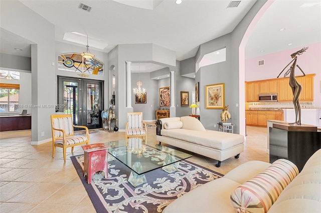 8100 Muirhead Cir, Boynton Beach, FL 33472 - living area with a towering ceiling, arched walkways, a chandelier, light tile patterned floors, and recessed lighting