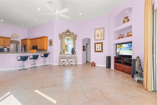 8100 Muirhead Cir, Boynton Beach, FL 33472 - living room with arched walkways, light tile patterned floors, ceiling fan, built in features, and recessed lighting