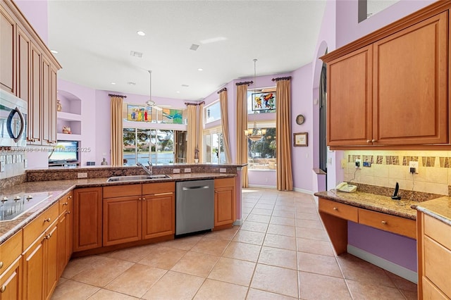 8100 Muirhead Cir, Boynton Beach, FL 33472 - kitchen with appliances with stainless steel finishes, decorative backsplash, light tile patterned flooring, light stone countertops, and a peninsula