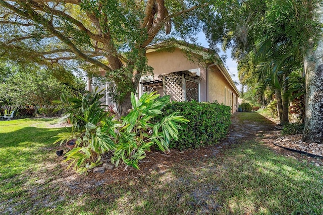 8100 Muirhead Cir, Boynton Beach, FL 33472 - view of property exterior with a yard and stucco siding