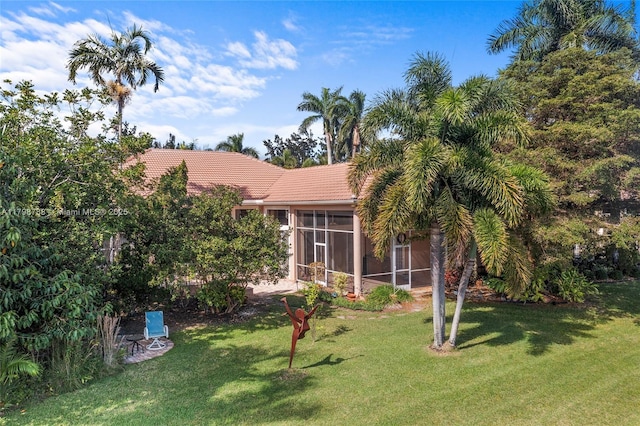 8100 Muirhead Cir, Boynton Beach, FL 33472 - back of property featuring a sunroom, a tile roof, and a lawn